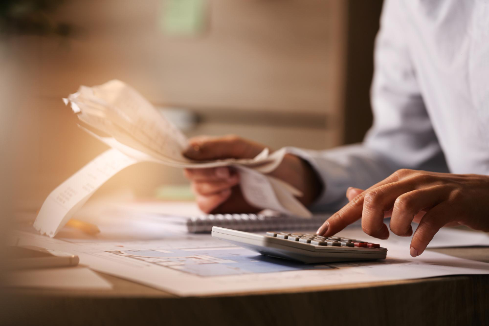closeup-economist-using-calculator-while-going-through-bills-taxes-office ما هو الرقم الضريبي في السعودية